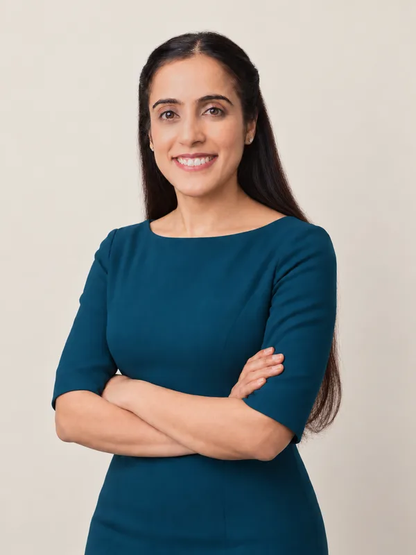 Dr. Chandeep Kaur smiling in a teal dress.